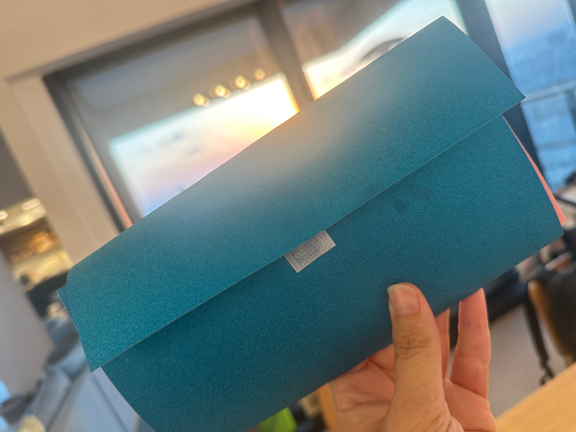 The folded card, closed and taped shut, ready to be handed to someone
