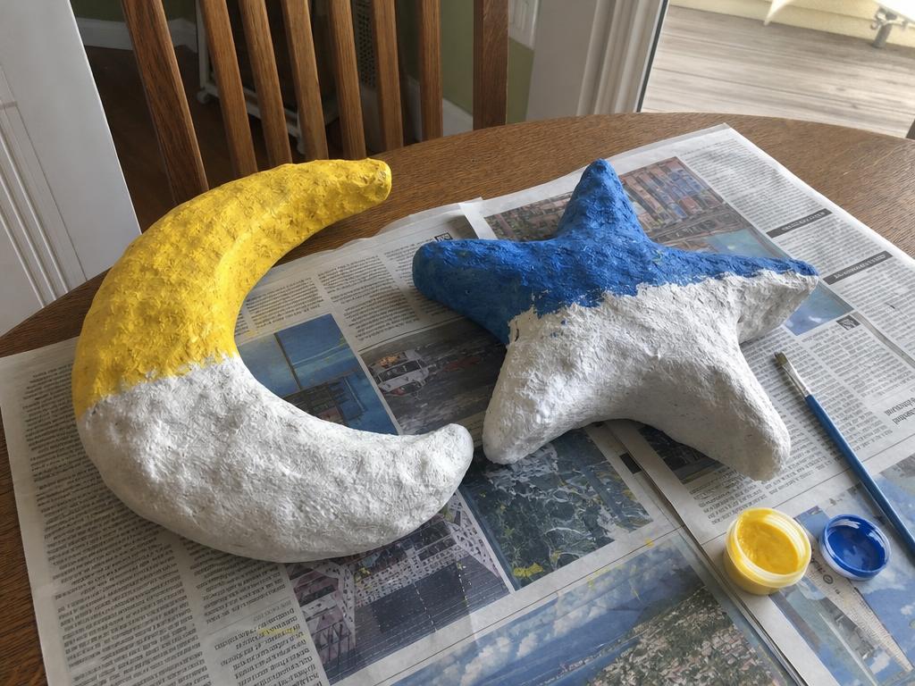 A moon and a star, drying and half painted.