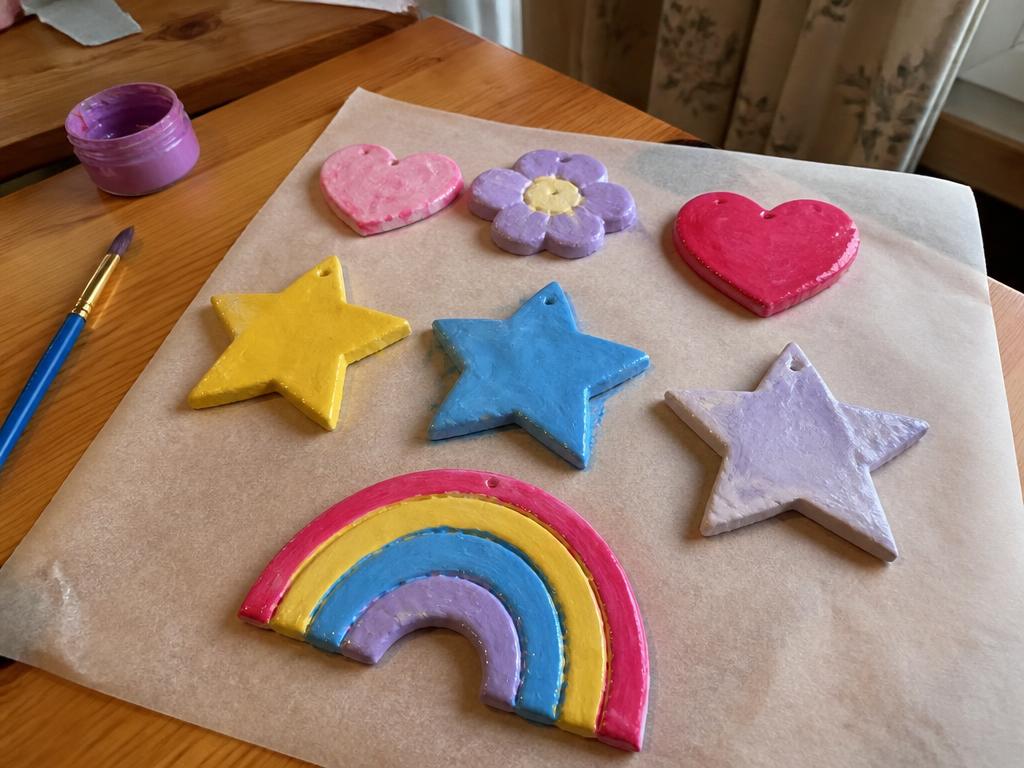 Shaping small clay pieces at the table with the magnets waiting