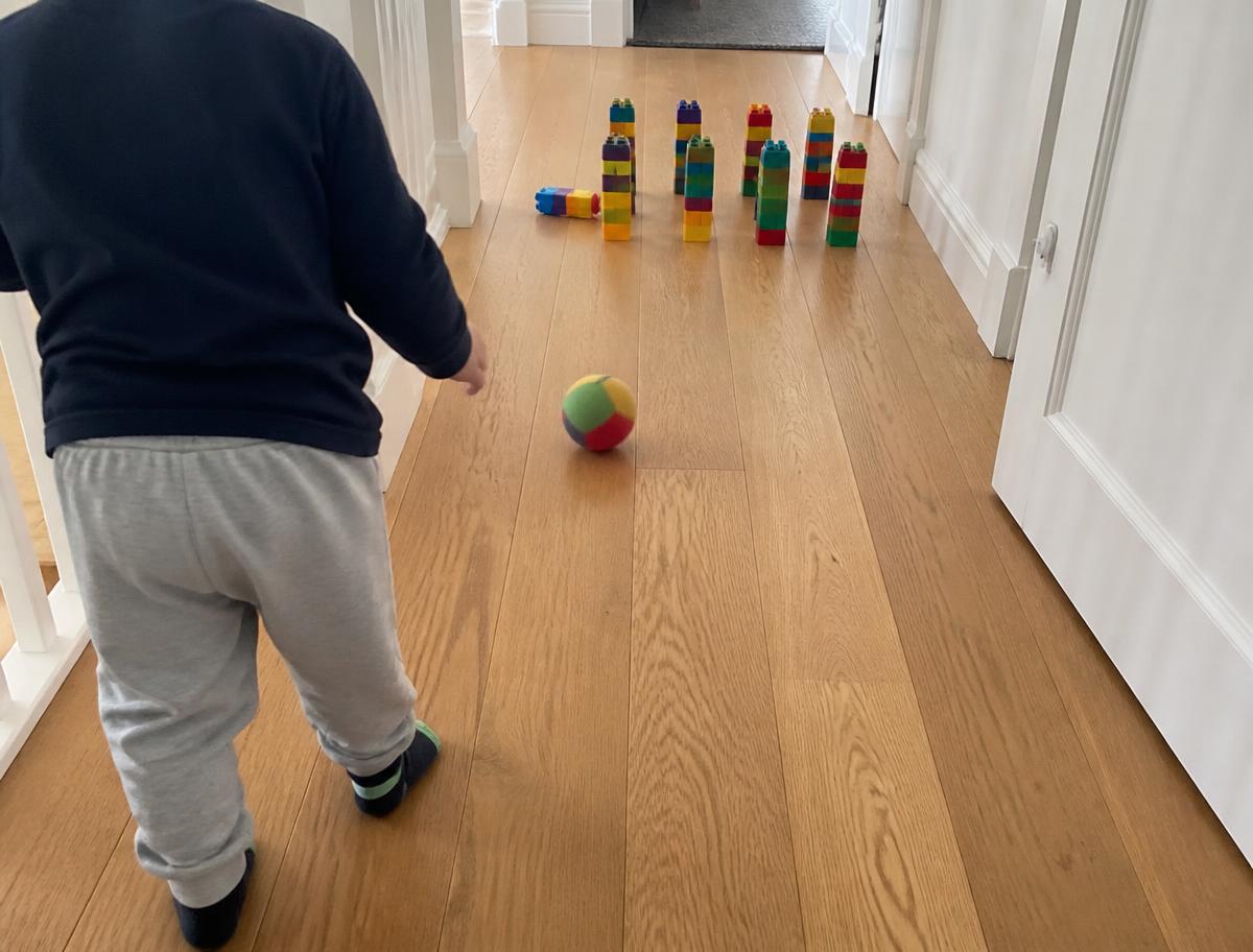 Ten brick towers in a hallway, one soft ball, endless rounds.