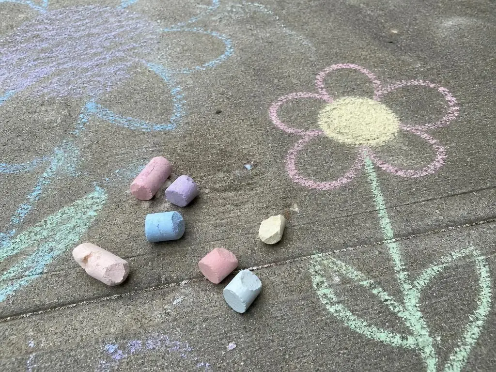 Dry sticks of homemade chalk and the first driveway drawings