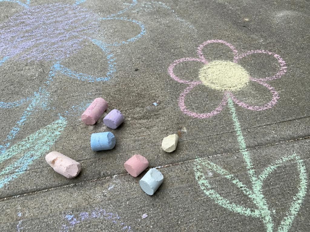 Dry sticks of homemade chalk and the first driveway drawings