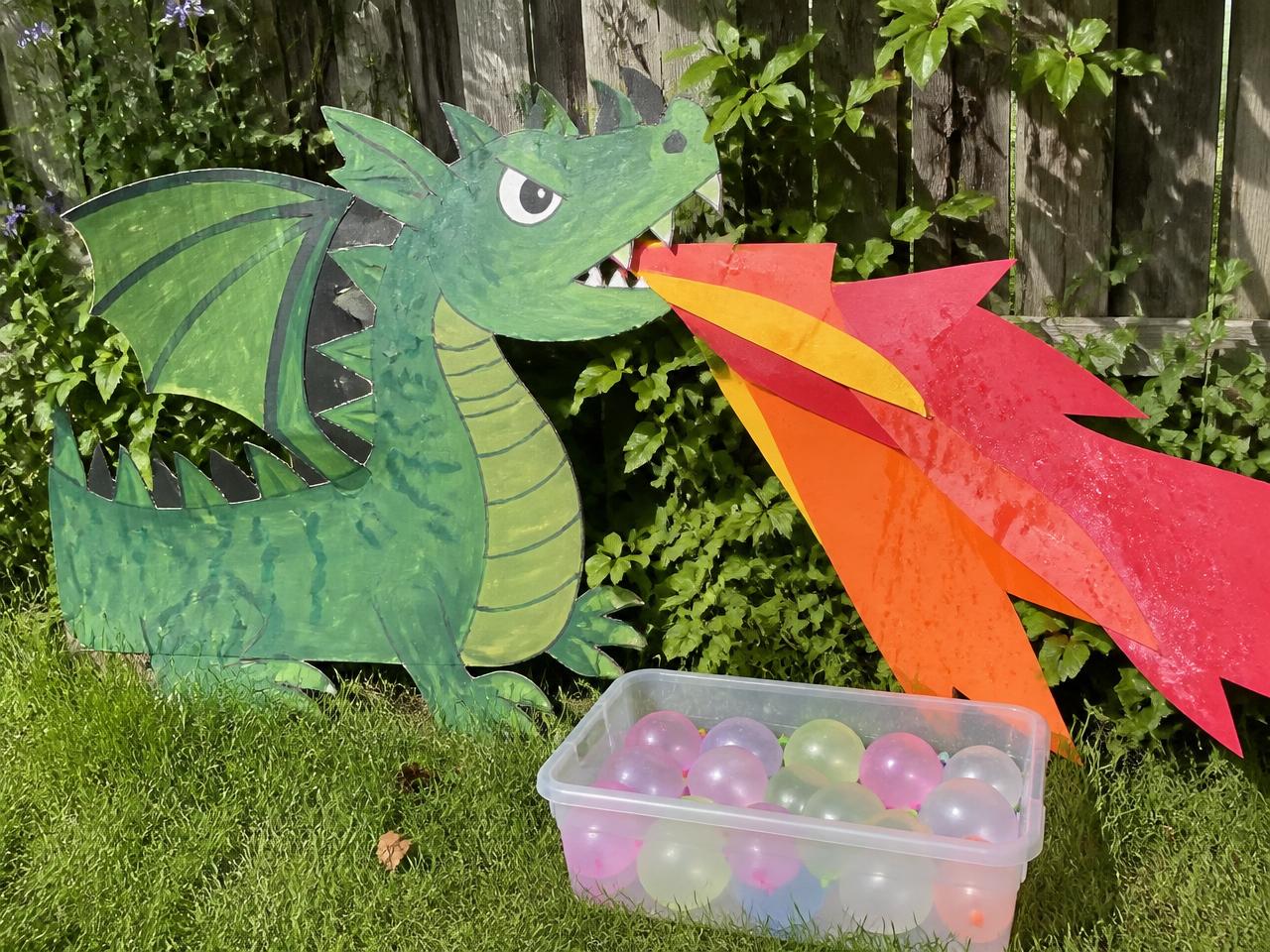 One poster board dragon and a tub of water balloons.
