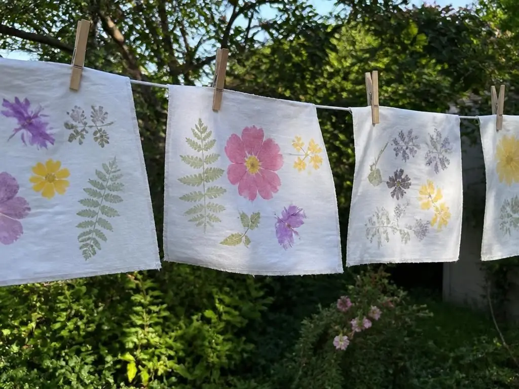 The printed cloths pegged on the line outside to set