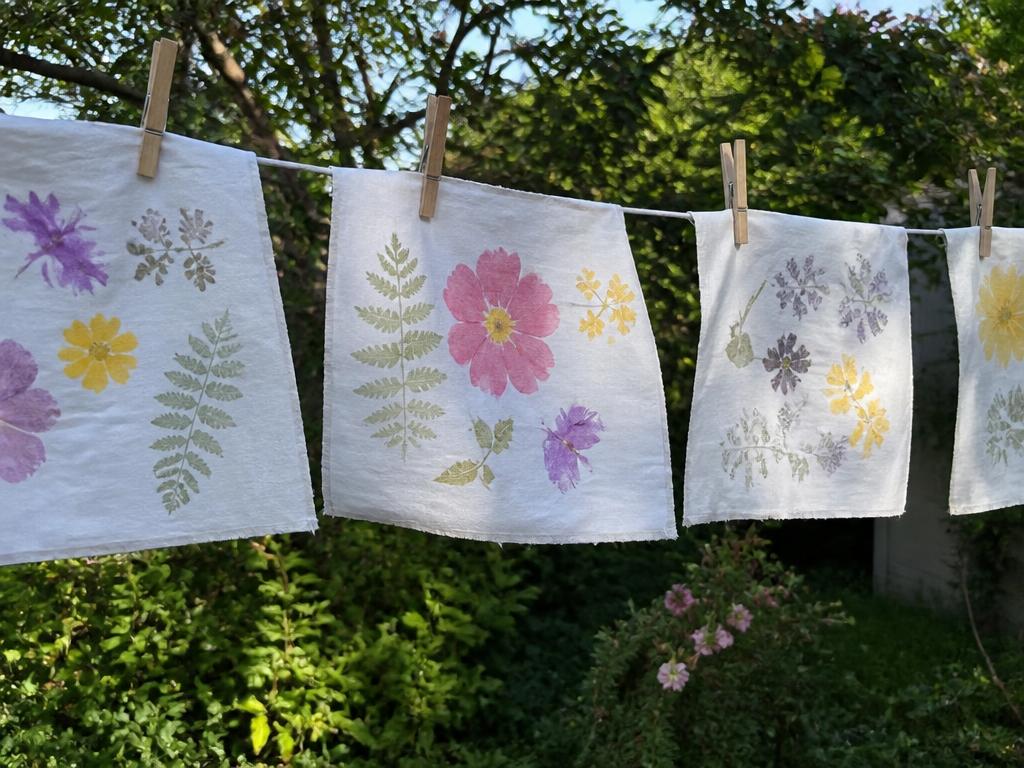 The printed cloths pegged on the line outside to set