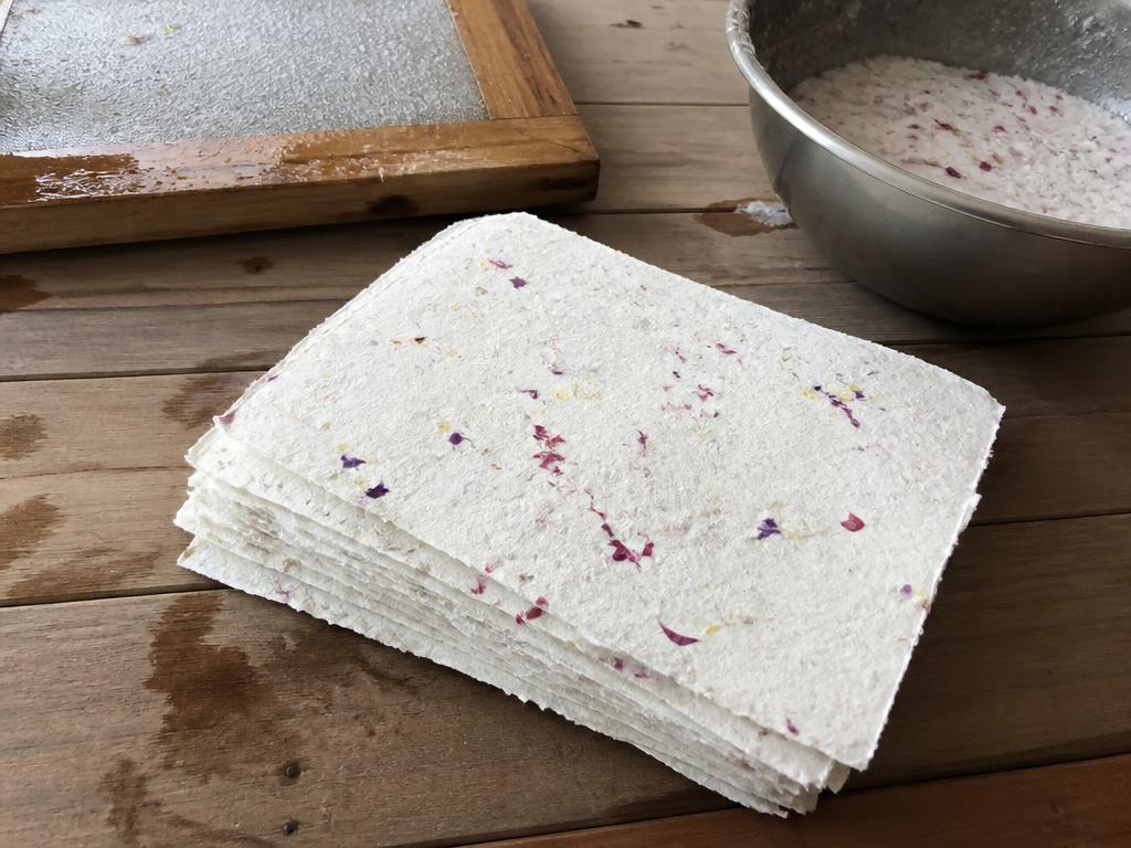 A stack of finished petal paper with soft deckled edges