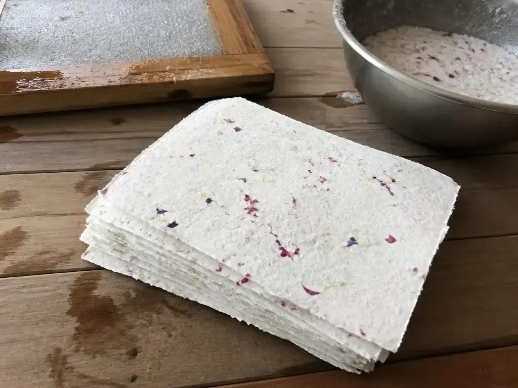 A stack of finished petal paper with soft deckled edges