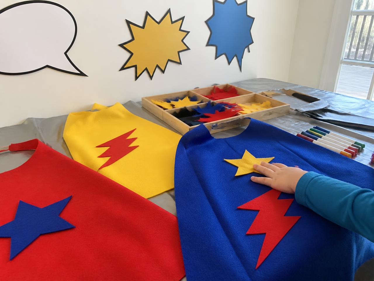 Felt capes, stick on stars and bolts, fabric markers.