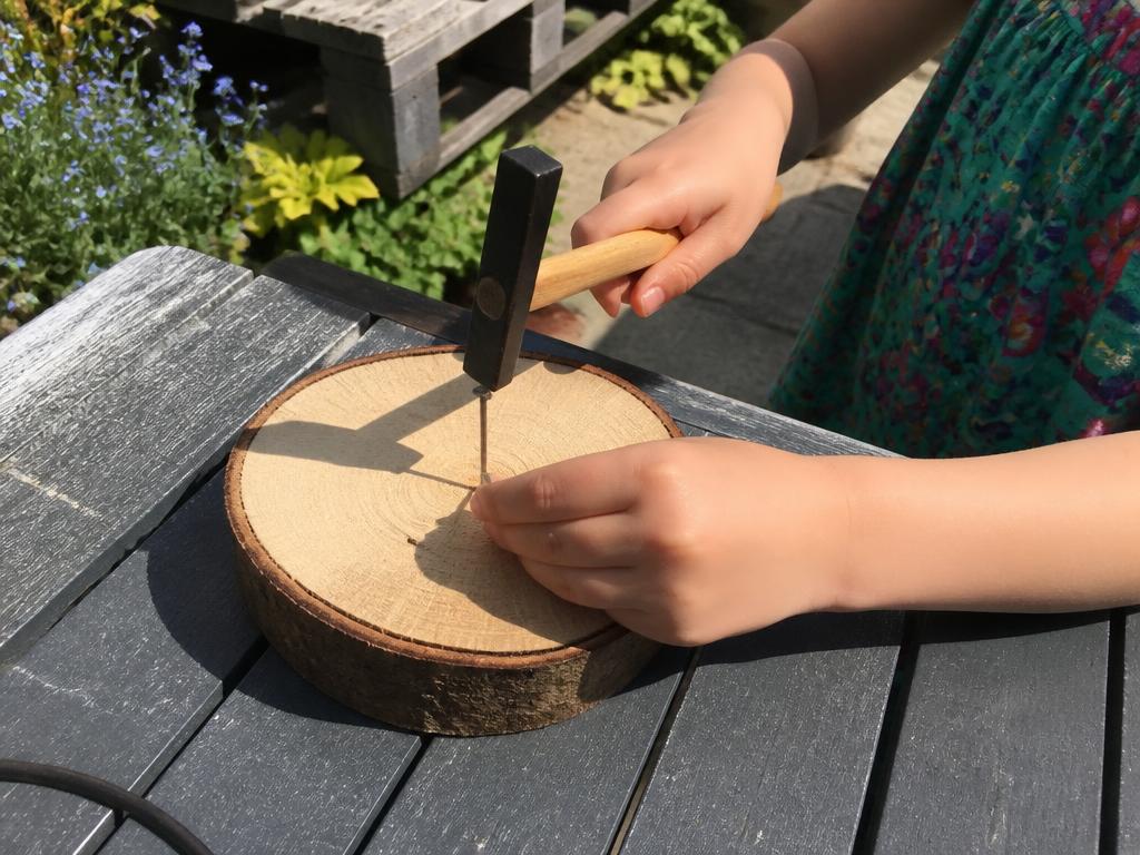 Both hands low and close to the wood — the safest grip for small hands.