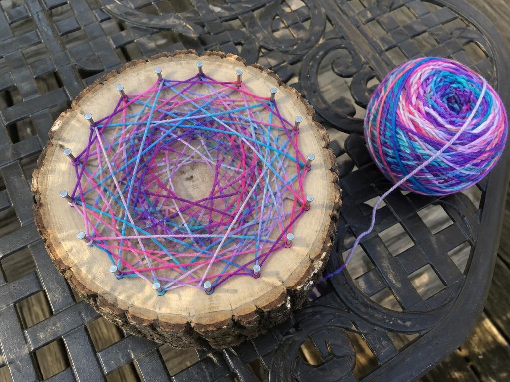 Nails around the edge, yarn wrapped freely — every slice ends up different.