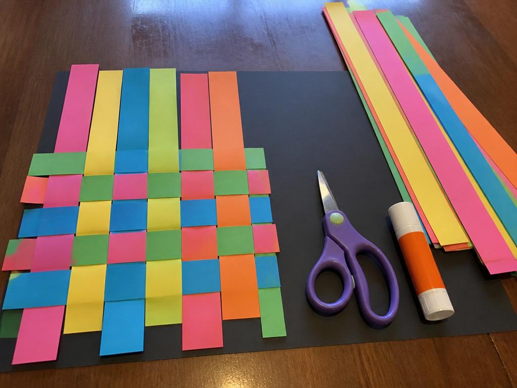 Halfway through the weaving, the rest of the strips waiting