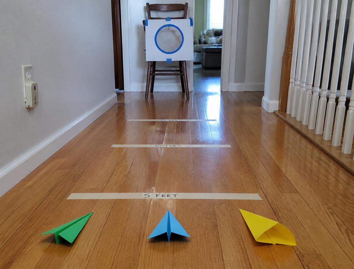 Masking tape distance lines and a card hoop taped to a chair.