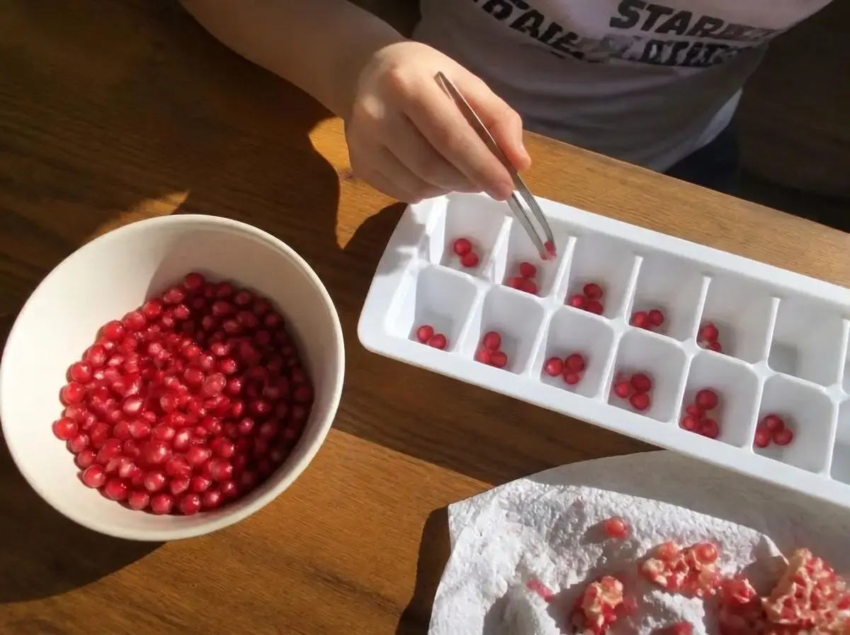 Tweezers plus an ice cube tray turns a snack into twenty minutes of focus.