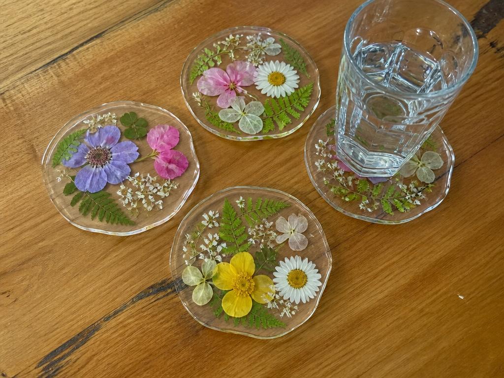 Pressed flowers sealed inside laminate and cut into coasters.