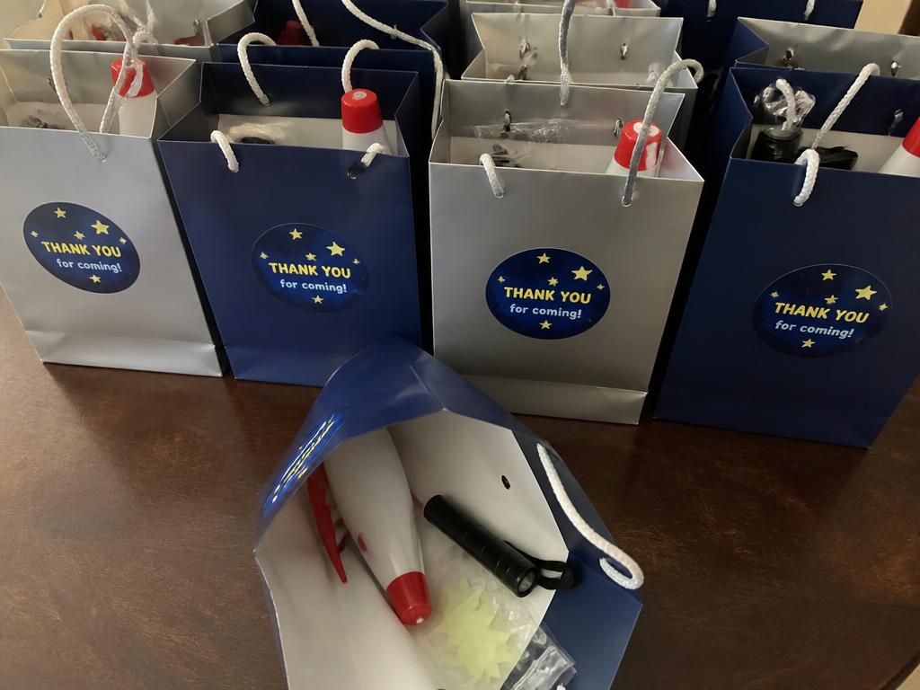 A mini torch, glow stars and a small rocket in each bag.