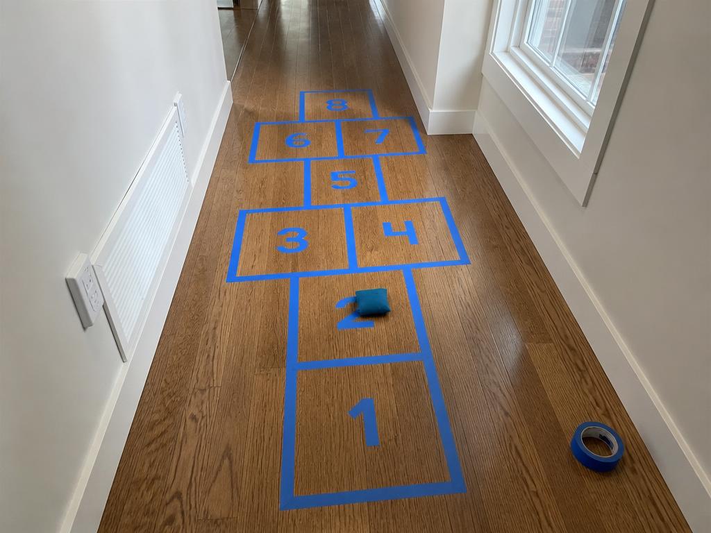 Hallway hopscotch — numbers written straight onto the tape.