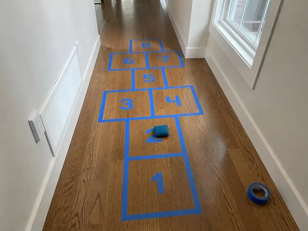 Hallway hopscotch — numbers written straight onto the tape.