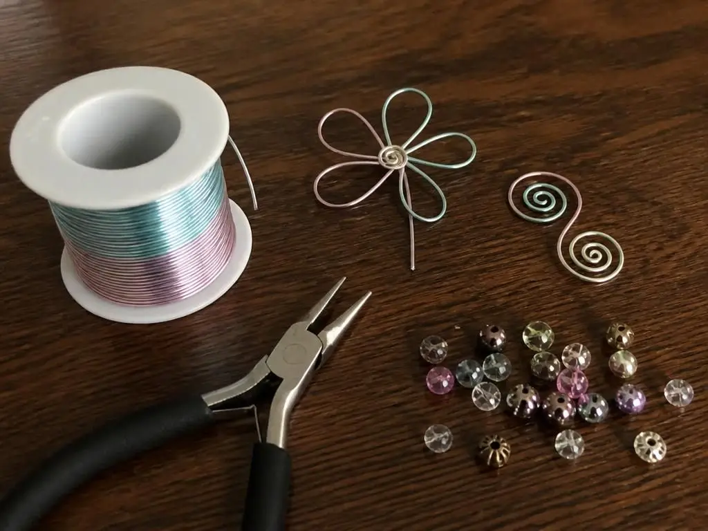 Soft craft wire, pliers, beads and the first finished flower