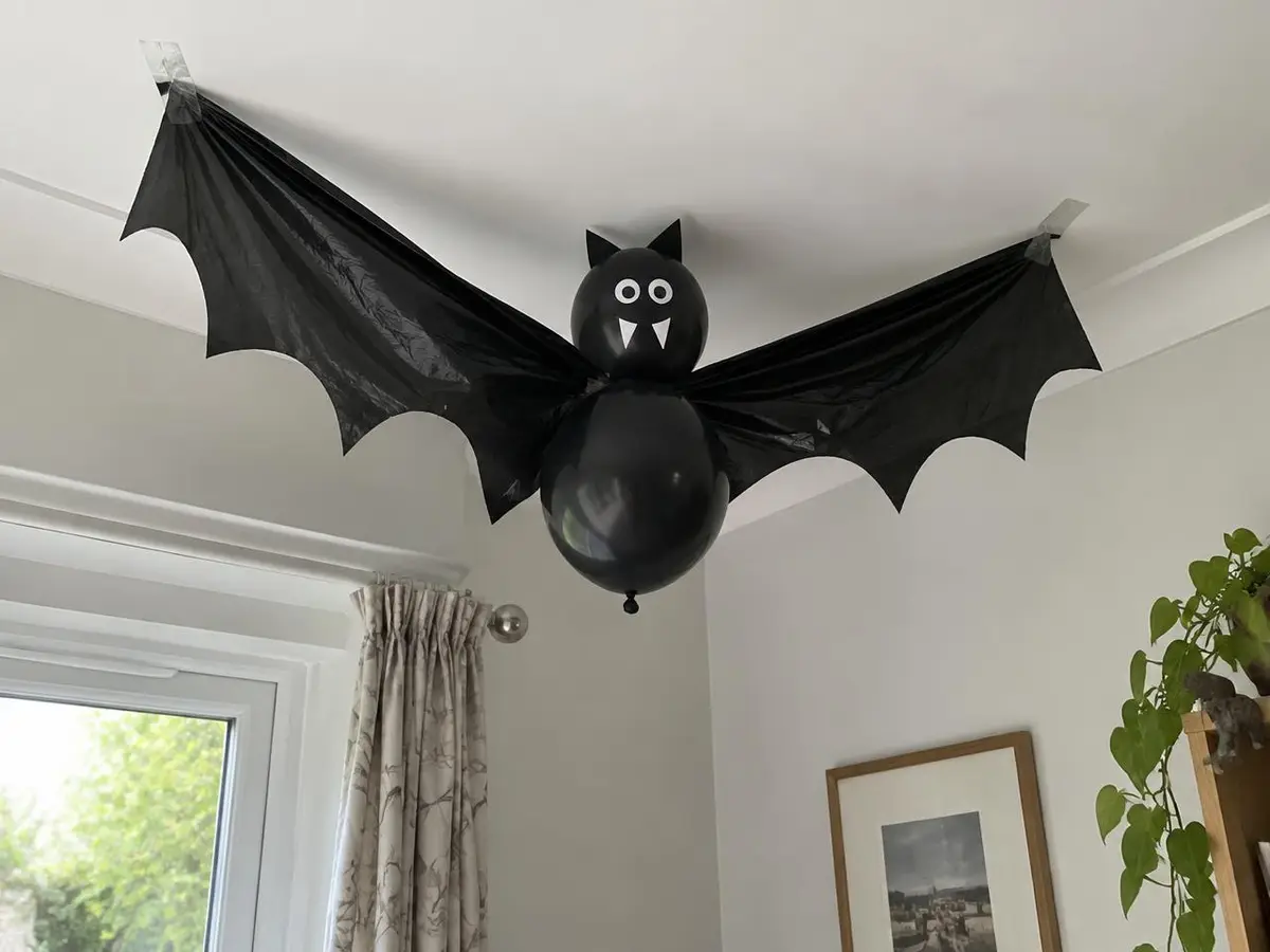 Two balloons, a bin bag and masking tape, about ten minutes per bat.